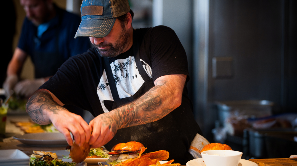 man cooking a burger in a fast casual restaurant