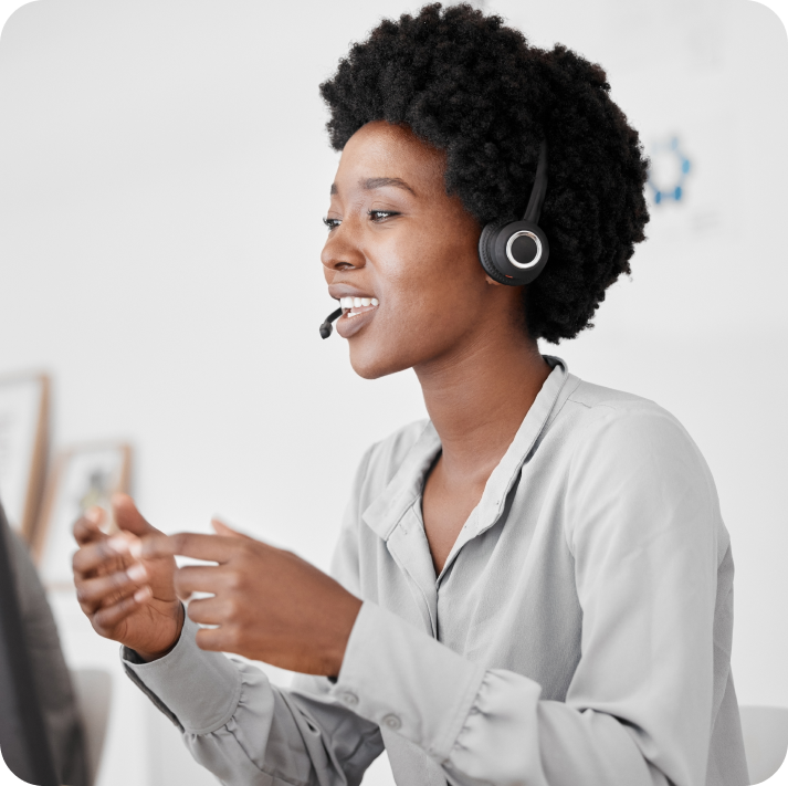 A female call center agent is addressing a customer on a call.