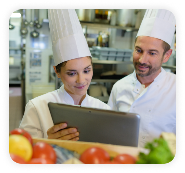 Two chefs using Modisoft full service restaurant point of sale application on a tablet.