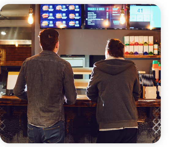 Two male customers viewing the digital menu at the restaurant.
