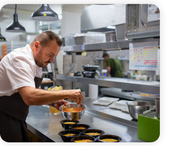 A chef is preparing food in the kitchen.