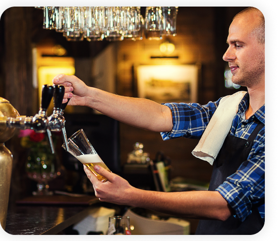 A bartender is extracting beer from the beer dispenser tap system.