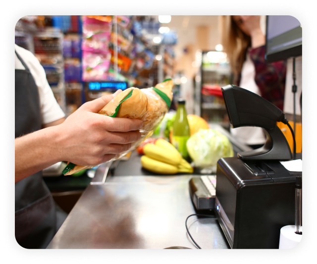 grocery cashier scanning a bag of chips