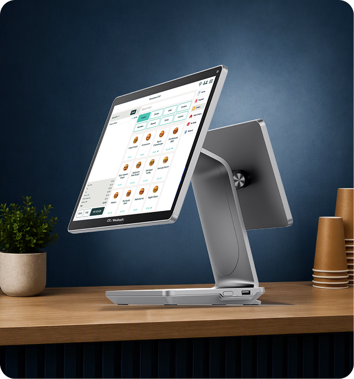 Modisoft point of sale terminal positioned on a countertop, touchscreen ordering software within a modern retail environment.